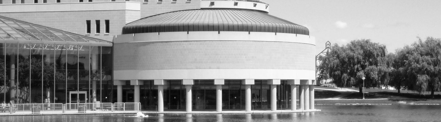 Dome shaped architectural building with a large pond infront of it